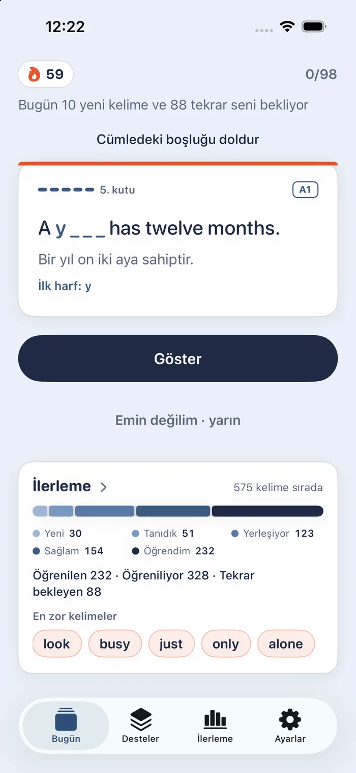 A gap-fill question: the sentence “Please sit s _ _ _ _ while I take your photo.”, its Turkish translation, the hint “first letter: s” and a Göster (“show”) button.