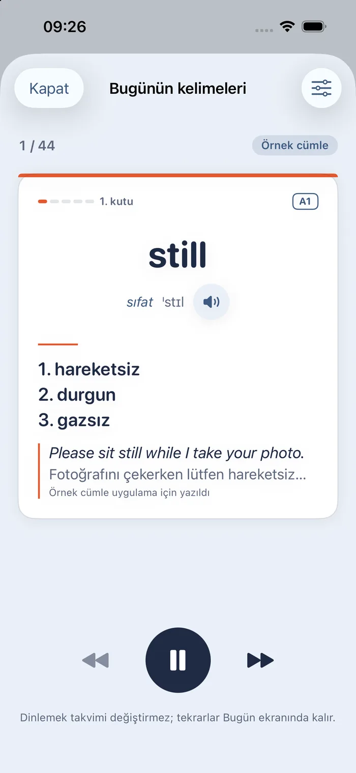 The listen screen “Today's words”, in Turkish: 1/44, an “example sentence” badge; the opened card for still (adjective, pronunciation, the meanings hareketsiz, durgun, gazsız and the example Please sit still while I take your photo.); below, previous, pause and next buttons; a note that listening does not change the schedule.